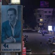 En banderoll med en bild på Bashar al-Assad i Damaskus.