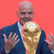 FIFA President Gianni Infantino gestures looking at the FIFA World Cup trophy at Moscow's Luzhniki Stadium, Russia, on Saturday, Sept. 9, 2017. From September 2017, the original trophy starts its tour over 24 Russian cities and more than 50 countries around the globe ahead of 2018 World Cup to start at Luzhniki stadium on June 14, 2018.