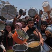 Palestinier kämpar för att få donerad mat den 26 juli.