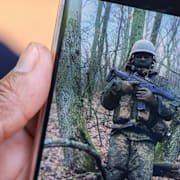 Charles Waithakas mor Bibiana Wangari visar en bild av sonen vid fronten i Ryssland. Familj och vänner under den symboliska begravningen. 