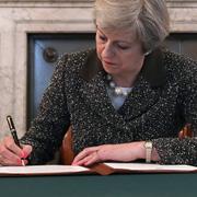 Theresa May undertecknar brevet  till Donald Tusk.