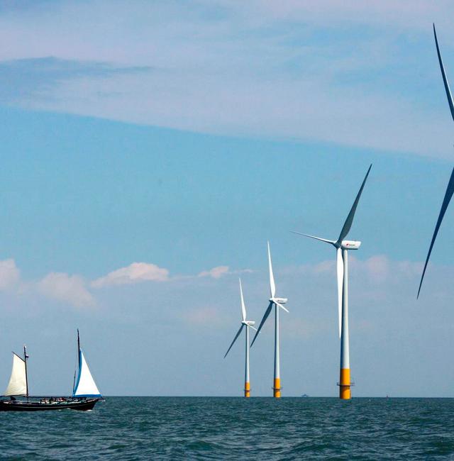 A vessel sails towards a wind farm off the coast of Whitstable on the north Kent coast in southeastern England. David Bebber / AP
