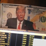 A picture of President Donald Trump on a hundred dollar bill is displayed at a post on the floor of the New York Stock Exchange in New York.