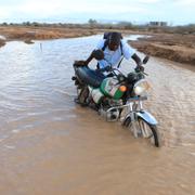 En motorcyklist i ett översvämmat Kenya, 7 november.