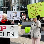 Protesters rally outside of a Tesla store in Boston, Saturday, March 1, 2025, against the company's CEO, Elon Musk, who is leading an effort to cut government jobs on behalf of President Donald Trump. (AP Photo/Rodrique Ngowi)  RPRN601