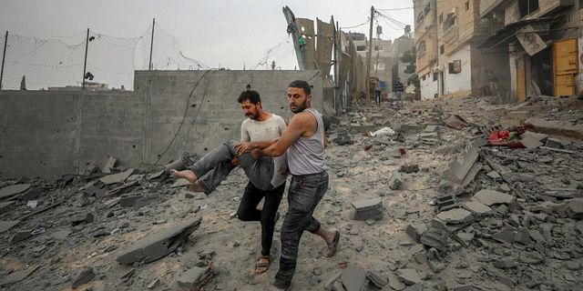 Palestinier bär bort skadade efter nattens israeliska motattacker. Mohammad Al Masri / AP