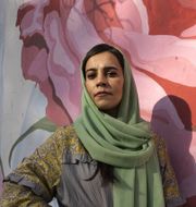 Women’s-rights activist Marjan Amiri stands beside a mural in Kabul depicting Farkhunda Malikzada, who was killed by a mob in the capital in 2015. Paula Bronstein for The Wall Street Journal
