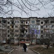 A civilian walks among heavily damaged residential buildings in Soledar, Donetsk region, Ukraine, Wednesday, Dec. 21, 2022.