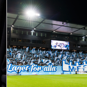 LB07:s logga och MFF-klacken under en av herrlagets matcher. 