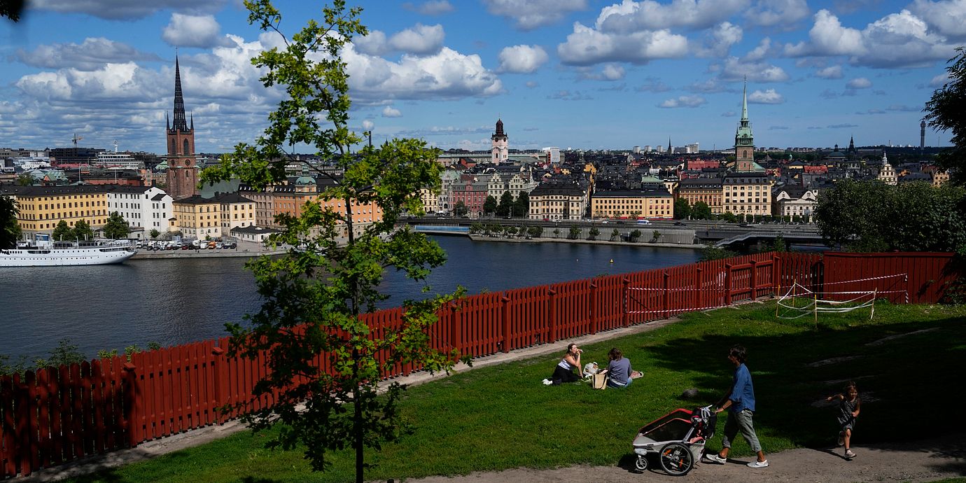 People enjoy sunny weather in a park in Stockholm, Sweden, Thursday, July 27, 2023. (AP Photo/Pavel Golovkin)  XPAG101