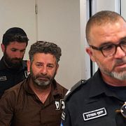 Den spansk-svenske akitvisten Saif Abukeshek eskorteras av fängelsepersonal på söndagen.