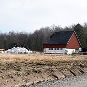 Räddningstjänsten har spärrat av ett större område på Hisingen efter att ett jordskred dragit med sig en ladugård och en häst.