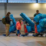 People line up to get on an overseas flight at OR Tambo International Airport in Johannesburg, South Africa, Nov. 26, 2021.