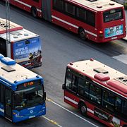 En blå och tre röda SL-bussar i Stockholm.