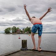 Barn hoppar från brygga