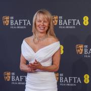 Pamela Anderson poses for photographers upon arrival at the 78th British Academy Film Awards, BAFTA's, in London, Sunday, Feb. 16, 2025. (Photo by Alberto Pezzali/Invision/AP)  LMT376