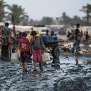 Palestinians gather to fill water jugs near one of the strip's few functioning desalination plants in Deir al-Balah, Gaza Strip, Thursday, June 20, 2024.