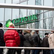 Folk köar utanför Sberbank i Moskva. Sberbank omfattas av den nya lagen.