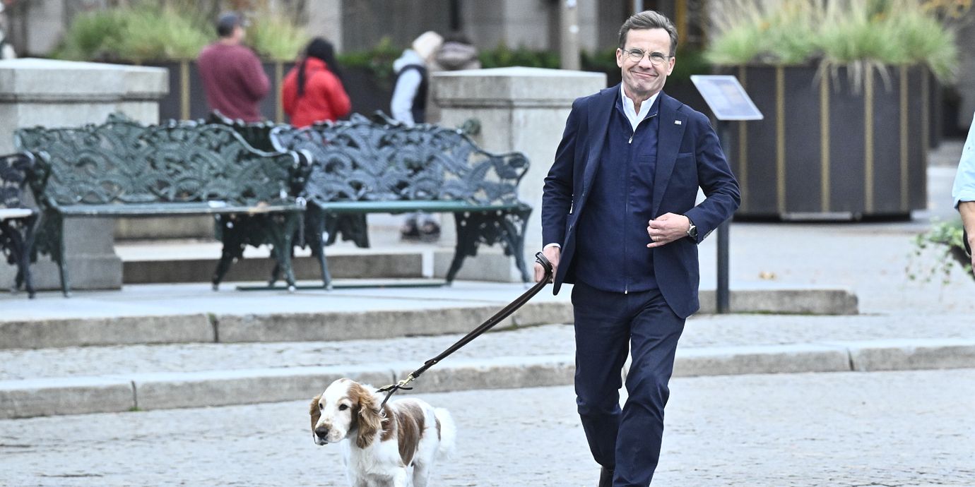 Ulf Kristersson (M) ute på promenad med hunden Winston.