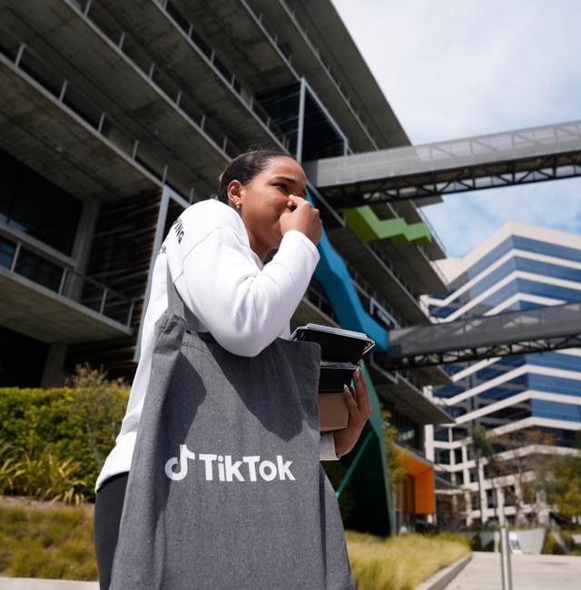 A TikTok Inc. employee walks outside the building in Culver City, Calif., Friday, March 17, 2023. Damian Dovarganes / AP
