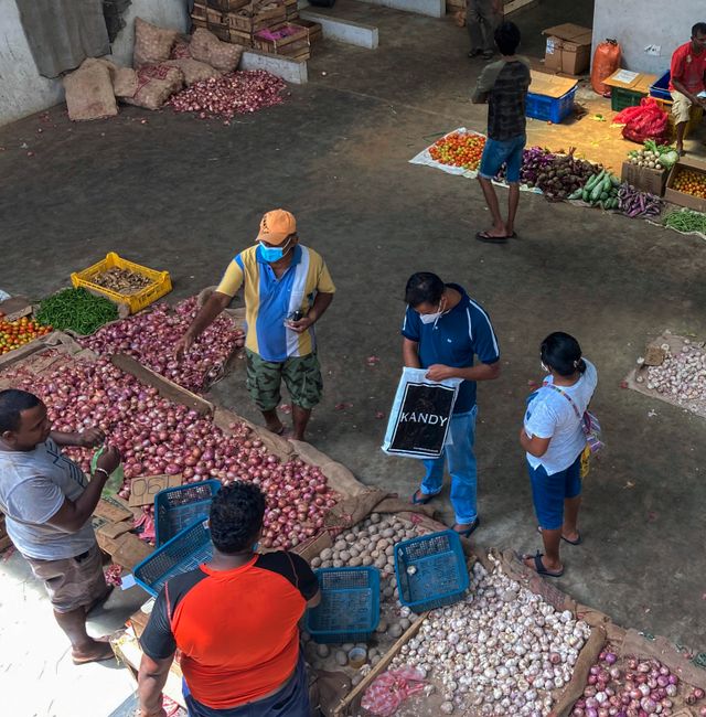 People purchase imported onions and garlic at a market in Colombo, Sri Lanka, Sunday, June 26, 2022. Eranga Jayawardena / AP