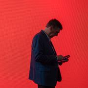 A visitor looks at his phone. (AP Photo/Pau Venteo)  PW112