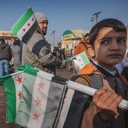  December 17th 2024. In the square below the Citadel of Aleppo, the revolutionary flag and pictures of HTS leader al-Jolani are being sold.