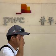 A man walks by the audit firm PricewaterhouseCoopers (PWC) office, at the Fortune Financial Center in Beijing on Tuesday, Aug. 27, 2024. 