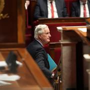 Michel Barnier lämnar parlamentet under en 