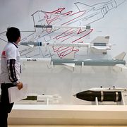 Besökare tittar på robotar och bomber tillverkade av ett kinesiskt företag under en vapenmässa i Peking. Arkivbild.