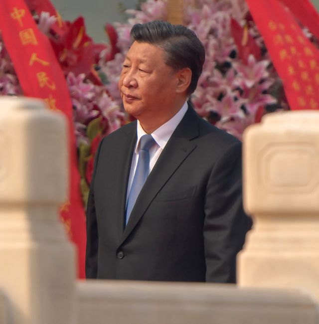 Chinese President Xi Jinping walks past floral bouquets during a ceremony to mark Martyr's Day at the Monument to the People's Heroes at Tiananmen Square in Beijing, Friday, Sept. 30, 2022. Mark Schiefelbein / AP