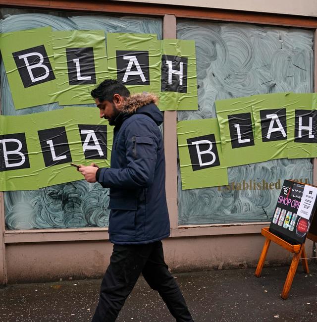A man walks past a shop with the phrase used by climate activist Greta Thunberg on it's windows as a protest organized by the Cop26 Coalition passes by in Glasgow, Scotland, Saturday, Nov. 6, 2021 which is the host city of the COP26 U.N. Climate Summit. Alberto Pezzali / TT NYHETSBYRÅN