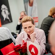 The leader of the Social Democrats, Mette Frederiksen talks with doubters from a meeting room at Christiansborg in Copenhagen, Tuesday, March 24, 2026.