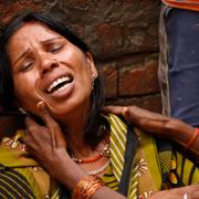 Kvinna i Mumbai sörjer en död anhörig.