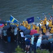Teams from Sri Lanka and Sweden on a boat travel by spectators along the Seine River in Paris, France, during the opening ceremony for the 2024 Summer Olympics.
