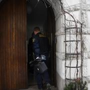 Polisen på väg in i porten där de hölls fångna.