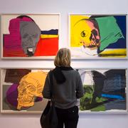 En besökare står framför Andy Warhols ”Skulls, 1976”  i utställningen på Kunsthaus i  Apolda i Tyskland 14 januari 2018.