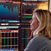 A fund manager looks at screens displaying activities of shares on the French Stock Exchange, in a financial analysis office in Paris, France, Tuesday, Aug. 25, 2015.