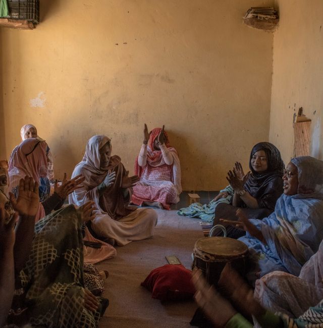 Female relatives and friends of Iselekhe Jeilaniy sing at her divorce party in Ouadane, a small town in the desert region of central Mauritania, April 24, 2023.  LAURA BOUSHNAK / NYT