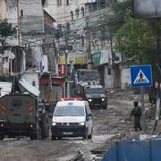 A Red Crescent ambulance passes by Israeli troops during an army raid in the Tulkarem refugee camp, West Bank, Wednesday, Jan.17, 2024. 