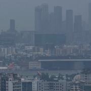 Air India aircrafts parked at Chhatrapati Shivaji Maharaj International Airport are seen behind city buildings in Mumbai, India, Tuesday, July 26, 2022. (AP Photo/Rafiq Maqbool)  RMX110