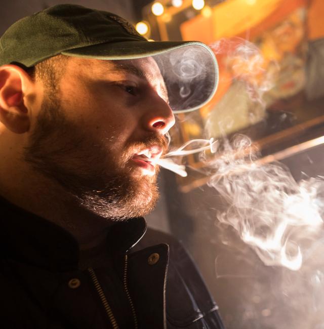 In this March 29, 2019, file photo, a man smokes marijuana at a Spleef NYC canna-cocktail party in New York. Mary Altaffer / AP