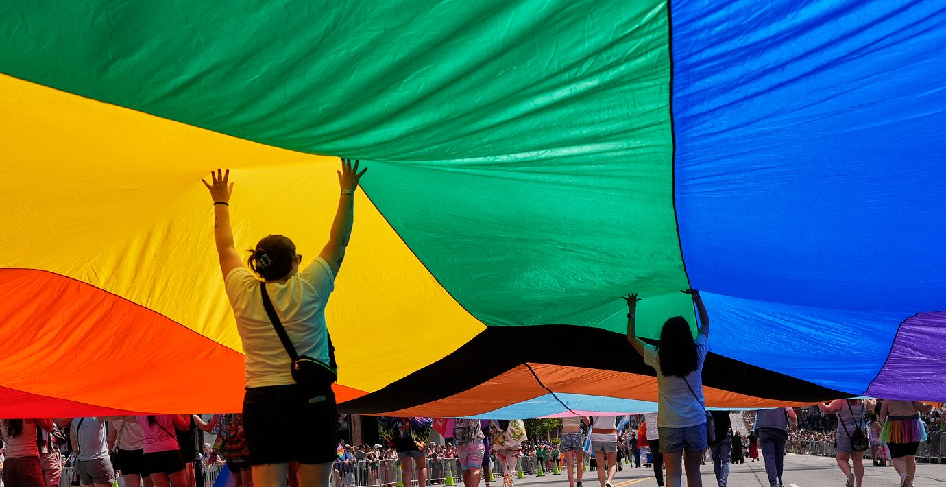 Deltagare håller upp en prideflagga under en parad i Nashville, USA. Illustrationsbild.