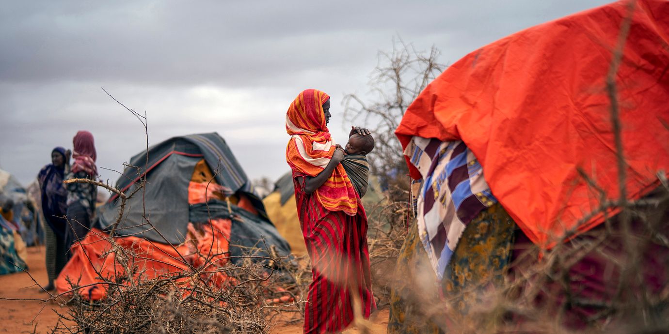 En kvinna fäller upp ett tält i ett flyktingläger i Dollow i Somalia. Arkivbild.