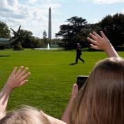 Tre flickor vinkar till president Donald Trump i slutet av oktober.