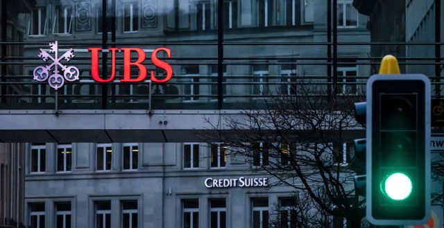 A traffic light signals green in front of the logos of the Swiss banks Credit Suisse and UBS in Zurich, Switzerland, Sunday March 19, 2023. (Michael Buholzer/Keystone via AP)  TH805 Michael Buholzer / AP
