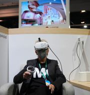 Kelly Taylor tries out a metaverse virtual shopping experience at the LOTTE Data Communication booth during the CES tech show Wednesday, Jan. 5, 2022, in Las Vegas. Joe Buglewicz / AP