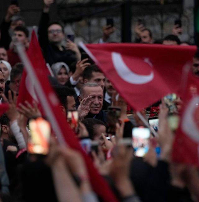 President Recep Tayyip Erdogan waves to supporters outside his residence in Istanbul. Francisco Seco / AP