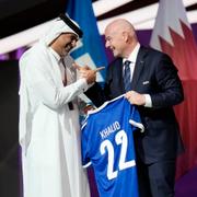 Prime Minister of the State of Qatar, Khalid Bin Khalifa Bin Abdulaziz Al Thani, left, receives a gift from FIFA President Gianni Infantino during the FIFA congress at the Doha Exhibition and Convention Center in Doha, Qatar, Thursday, March 31, 2022. (AP Photo/Hassan Ammar)  HAS108