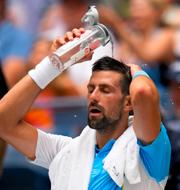 Novak Djokovic, of Serbia, pours water on his head to cool off between sets against Taylor Fritz, of the United States, during the quarterfinals of the U.S. Open tennis championships, Tuesday, Sept. 5, 2023, in New York.